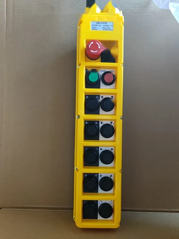 Close-up of AR1-67CD front panel showing black buttons, arrow tips, and emergency stop