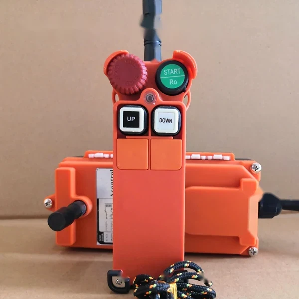 Orange industrial wireless remote control pendant with start, up, and down buttons and a receiver box