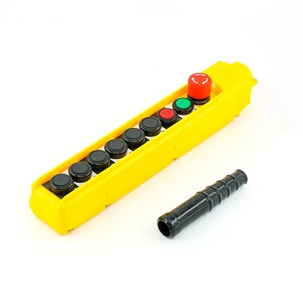 Yellow industrial pendant control station with black push buttons, green button and red emergency stop, plus black cable gland