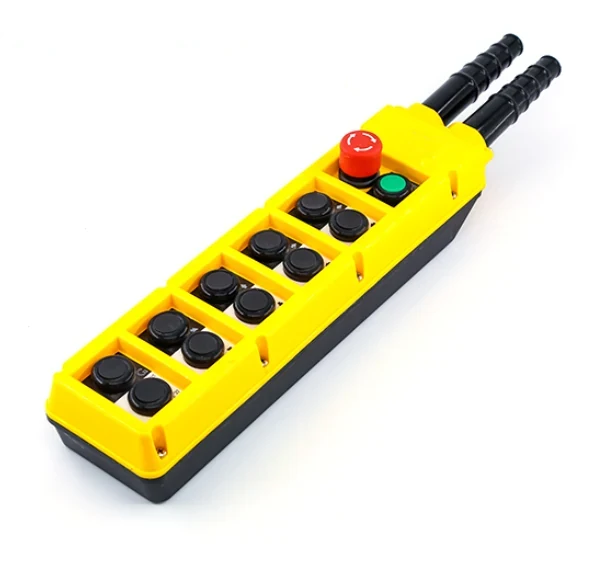 Yellow industrial pendant control station with black push buttons, red emergency stop, and green start button