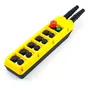 Yellow industrial pendant control station with black push buttons, red emergency stop, and green start button