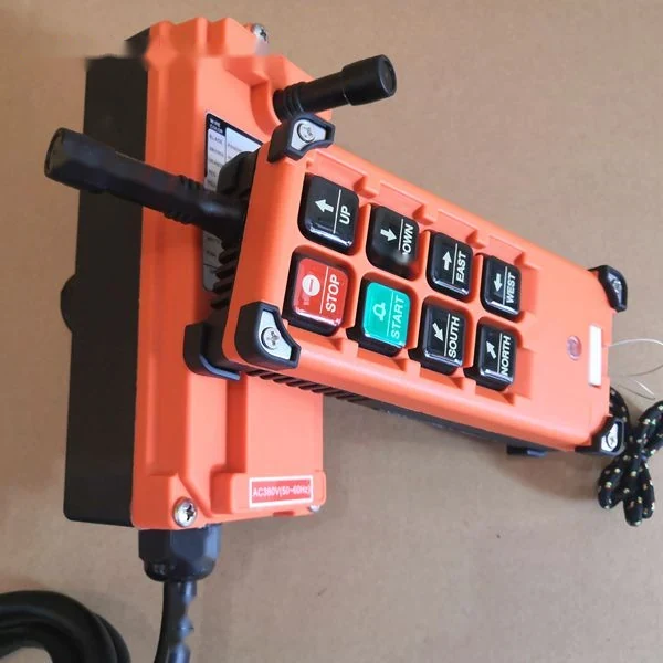 Orange industrial wireless remote control pendant with directional buttons and emergency stop