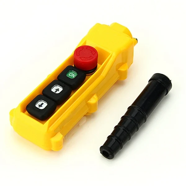 Yellow pendant control station with red emergency stop, green ON and arrow buttons, plus a black rubber boot