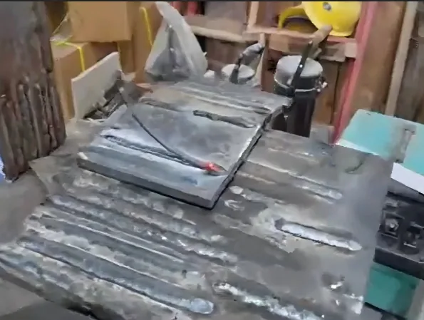Welded test plates on a workshop bench