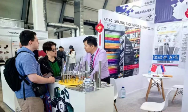 Shaanxi Jiade Import and Export stand with visitors at INNOPROM 2024 in Yekaterinburg