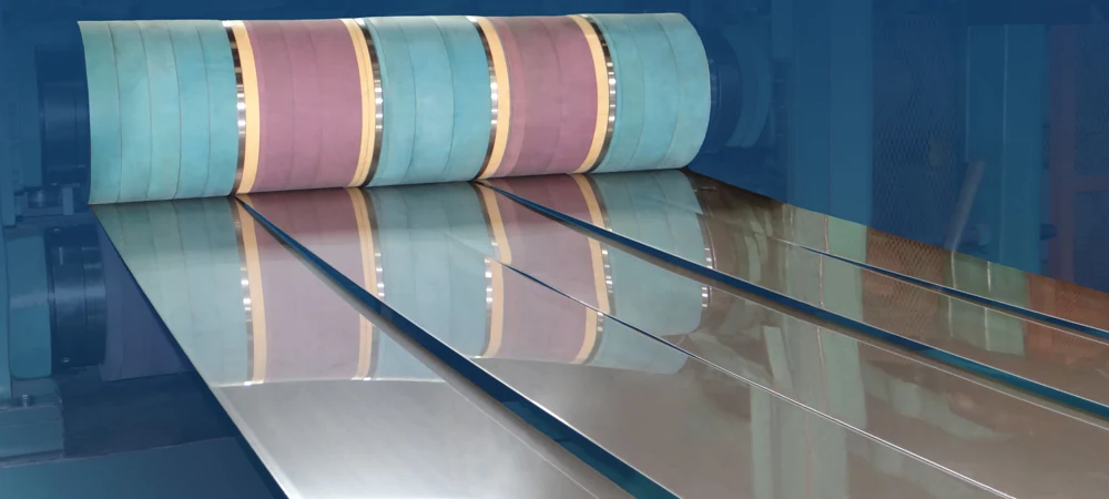 Stainless steel strip being slit and edge conditioned on the line