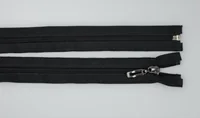 Two black zippers with metal sliders and pulls lying horizontally on a white background.
