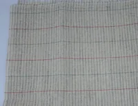 Close-up of beige ribbed woven fabric sample with thin red and green horizontal stripes and fringed top edge