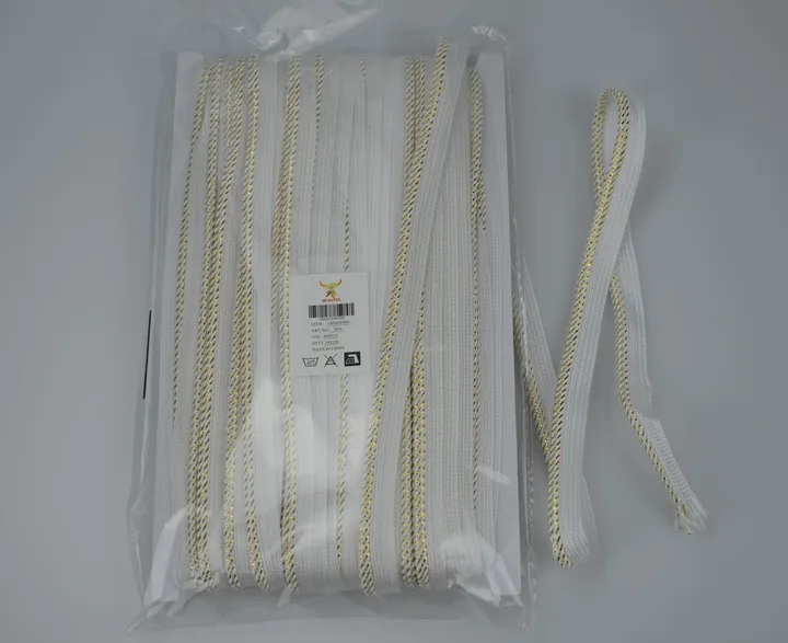 Packaged white and gold braided trim with MUSATEX product label and barcode on a white background