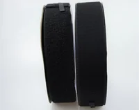Two rolls of black hook-and-loop fastener tape side by side on a white background
