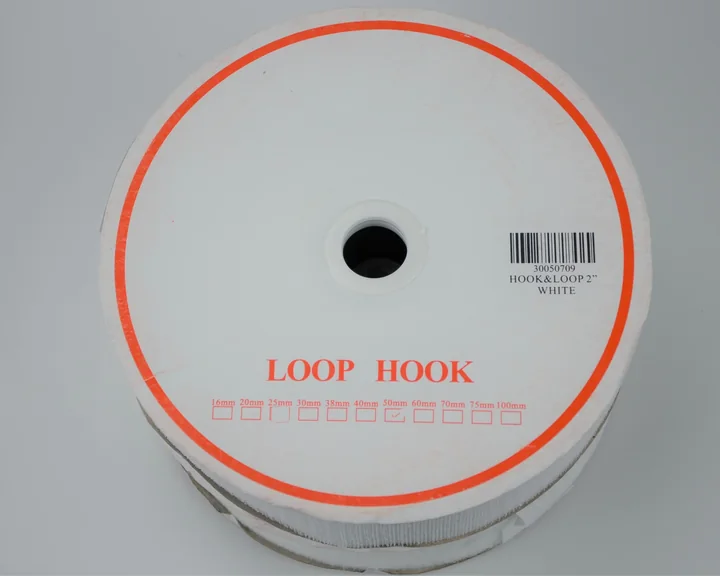 Round white disc of hook-and-loop fastener tape labeled LOOP HOOK with barcode label, on plain background
