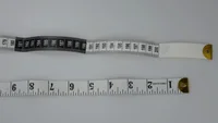 Two fiberglass body measuring tapes, one black and one white, on a plain white background.