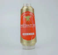 A large cone of metallic gold yarn with a red MUSATEX label.