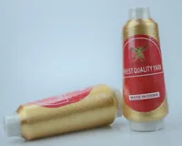 Two cones of gold metallic yarn with MUSATEX labels, one standing and one lying down.