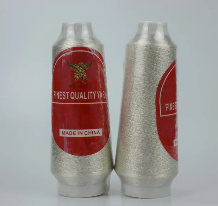 Two cones of silver metallic thread with red MUSATEX labels.