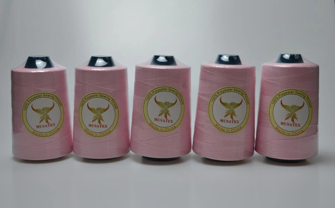 Five pink sewing thread cones with MUSATEX phoenix labels lined up on a white background