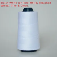 White sewing thread wound on a