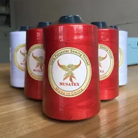 Red and white MUSATEX polyester sewing thread cones with phoenix logo labels on a wooden table