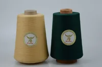 Two yarn cones, beige and dark green, with branded labels on a plain light background