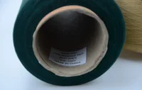 Dark green polyester yarn cone with MUSATEX paper label reading 100% Polyester Yarn, 32S/1, Made in China