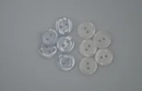 Cluster of round two-hole buttons, marbled blue-gray and white, on a plain gray background