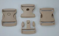 Four tan plastic side-release buckle components arranged on a plain light background.