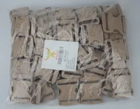 Bulk package containing tan plastic side release buckles with a white MUSATEX label.
