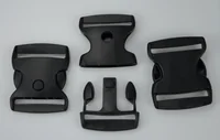 Four black plastic side-release buckles arranged on a plain light gray background