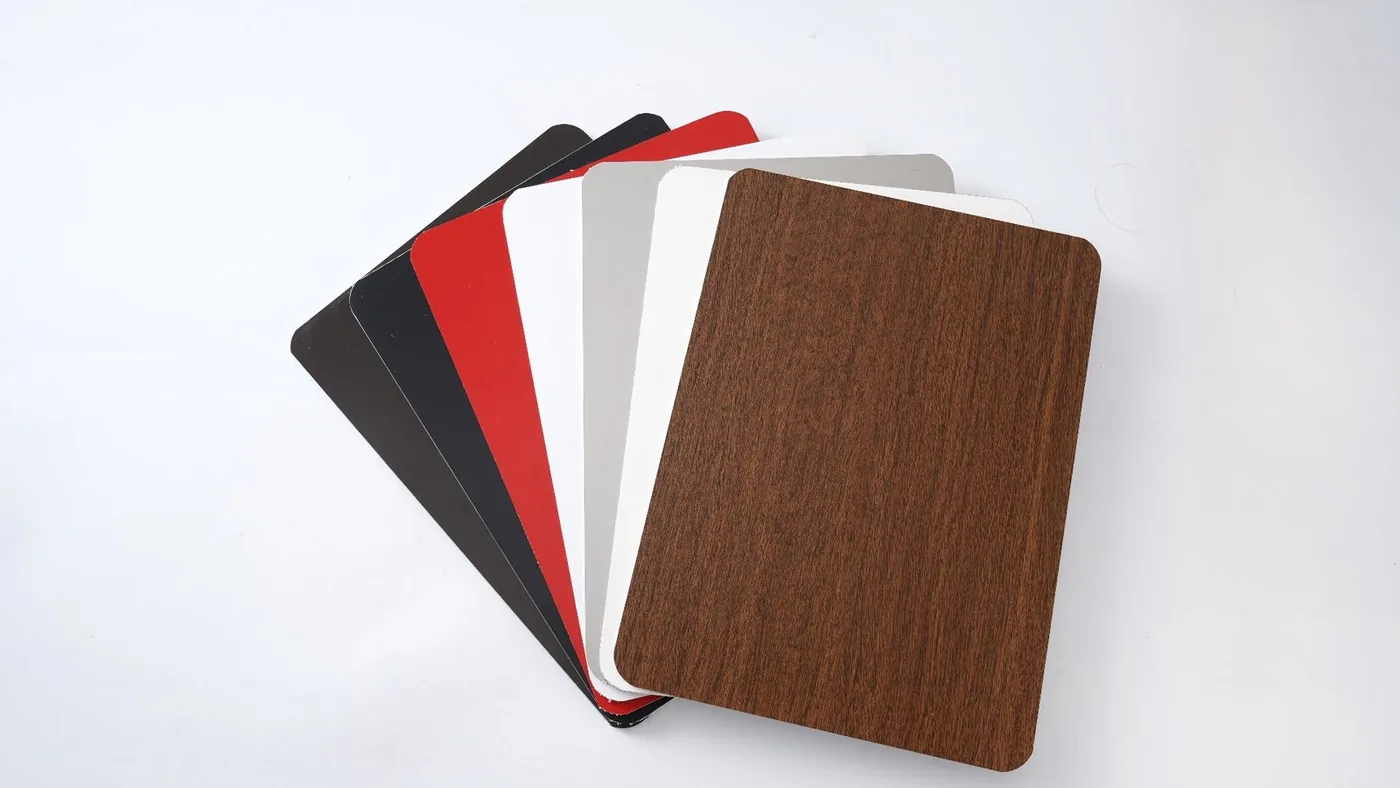 Fan of real ACP colour samples in wood-grain, metallic and solid finishes