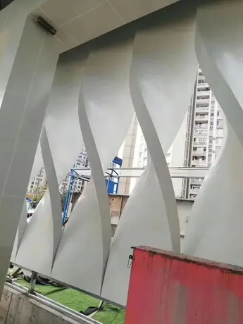 Aluminum perforated fence protecting PPG painted panel