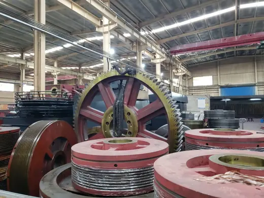Large gears and drive wheels staged before assembly at the Anchors Machinery works in Ningbo China