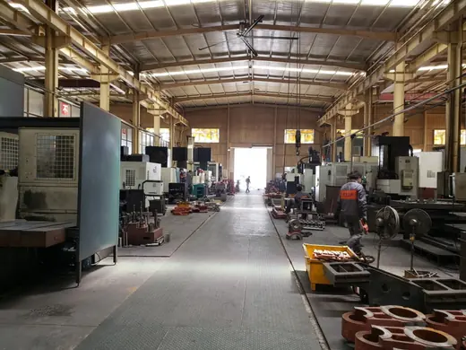 Machine tools on both sides of the main workshop aisle at the Anchors Machinery works in Ningbo China
