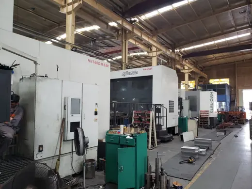 Machining centres and control cabinets along the working aisle at the Anchors Machinery works in Ningbo China