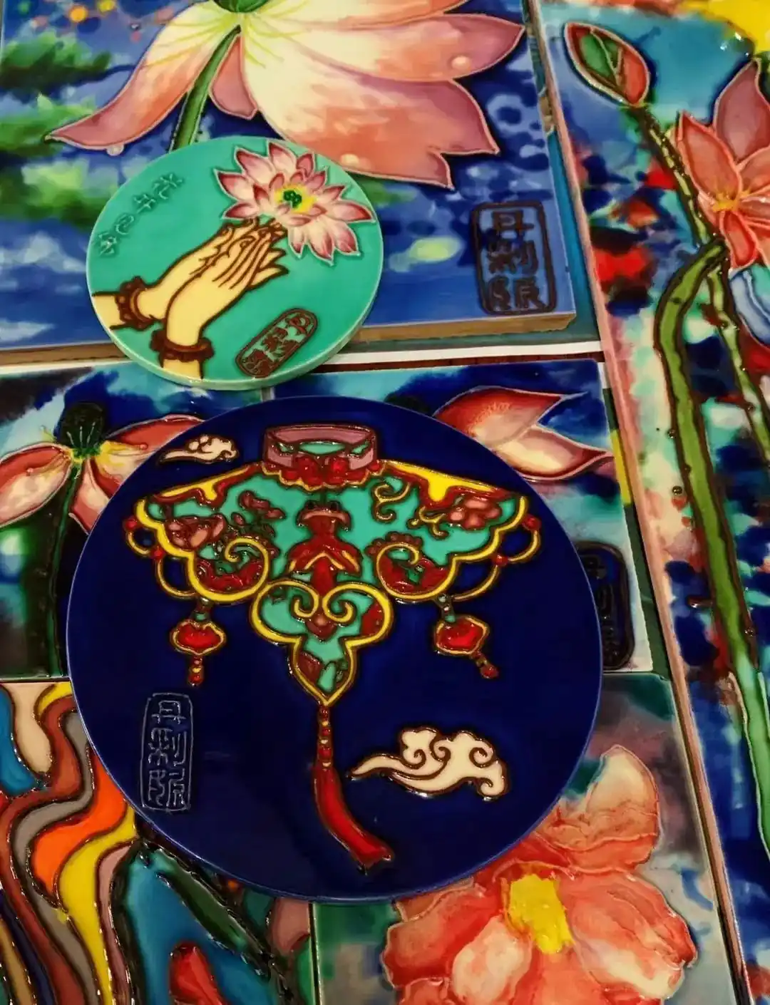 Finished hand painted ceramic tiles with cobalt blue and lotus motifs after high temperature firing