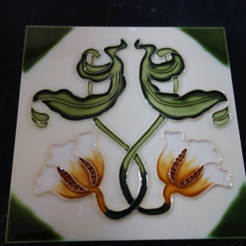 Handmade decorative ceramic tile with relief floral motif