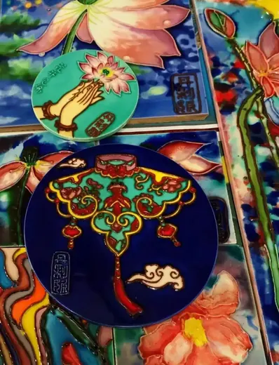 Fired tiles showing the glossy colour of hand painted ceramic tile after kiln firing