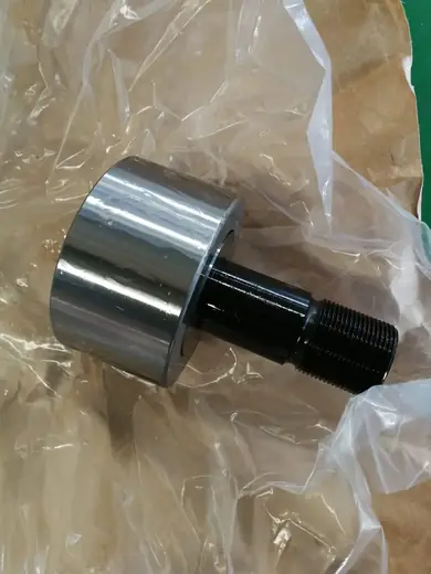 Stud type roller bearings for conveyor systems