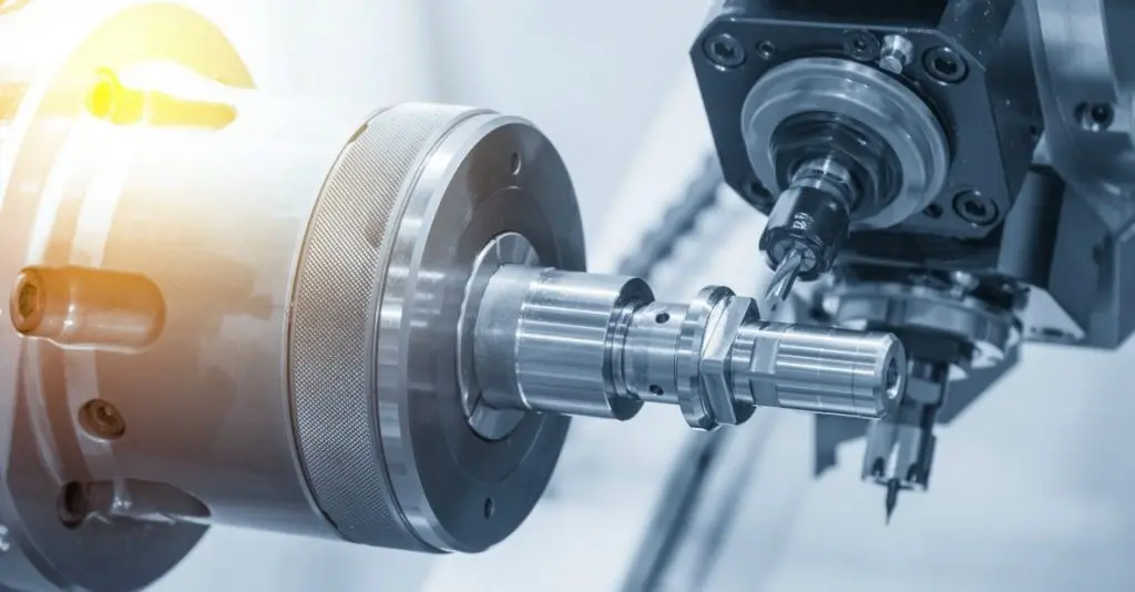 CNC turning a precision steel shaft on a lathe