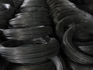 Coils of black iron wire stacked in the warehouse