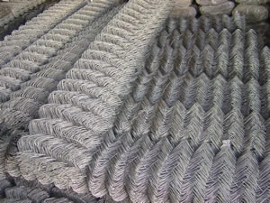 Rolls of galvanized chain link fence stacked for shipment