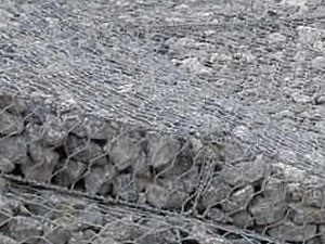 Gabion mattress filled with stone on a river bank