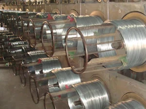Galvanized wire spools on the drawing line in the plant