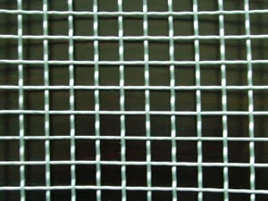 Square woven wire mesh with a green tint