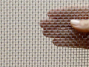 Fine square wire mesh held between two fingers