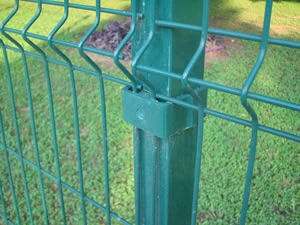 Green welded mesh fence panel bolted to a post
