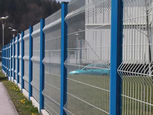 Welded mesh fence panels on blue posts beside a road
