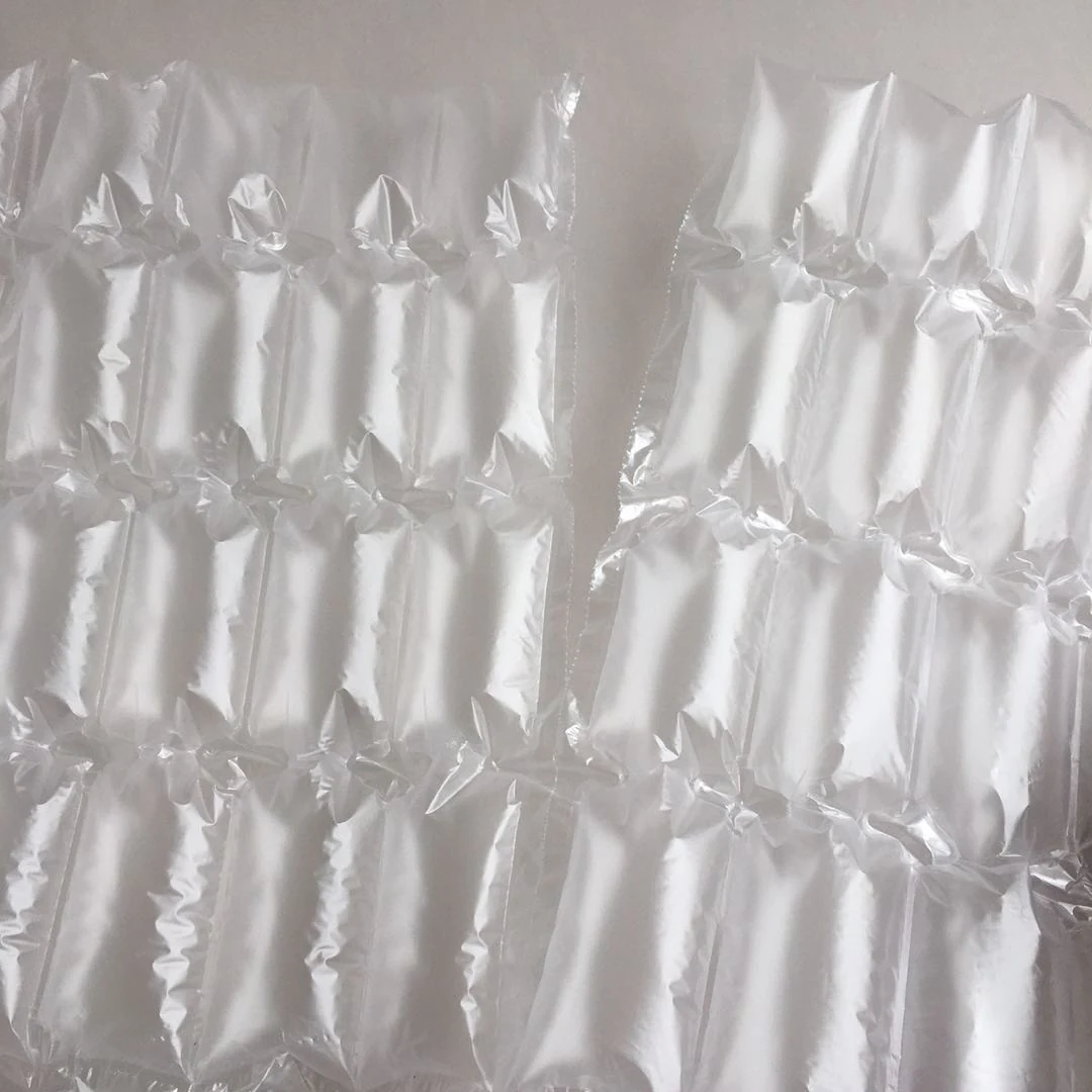 Two translucent inflatable air column packaging sheets lying flat on a plain light-colored surface