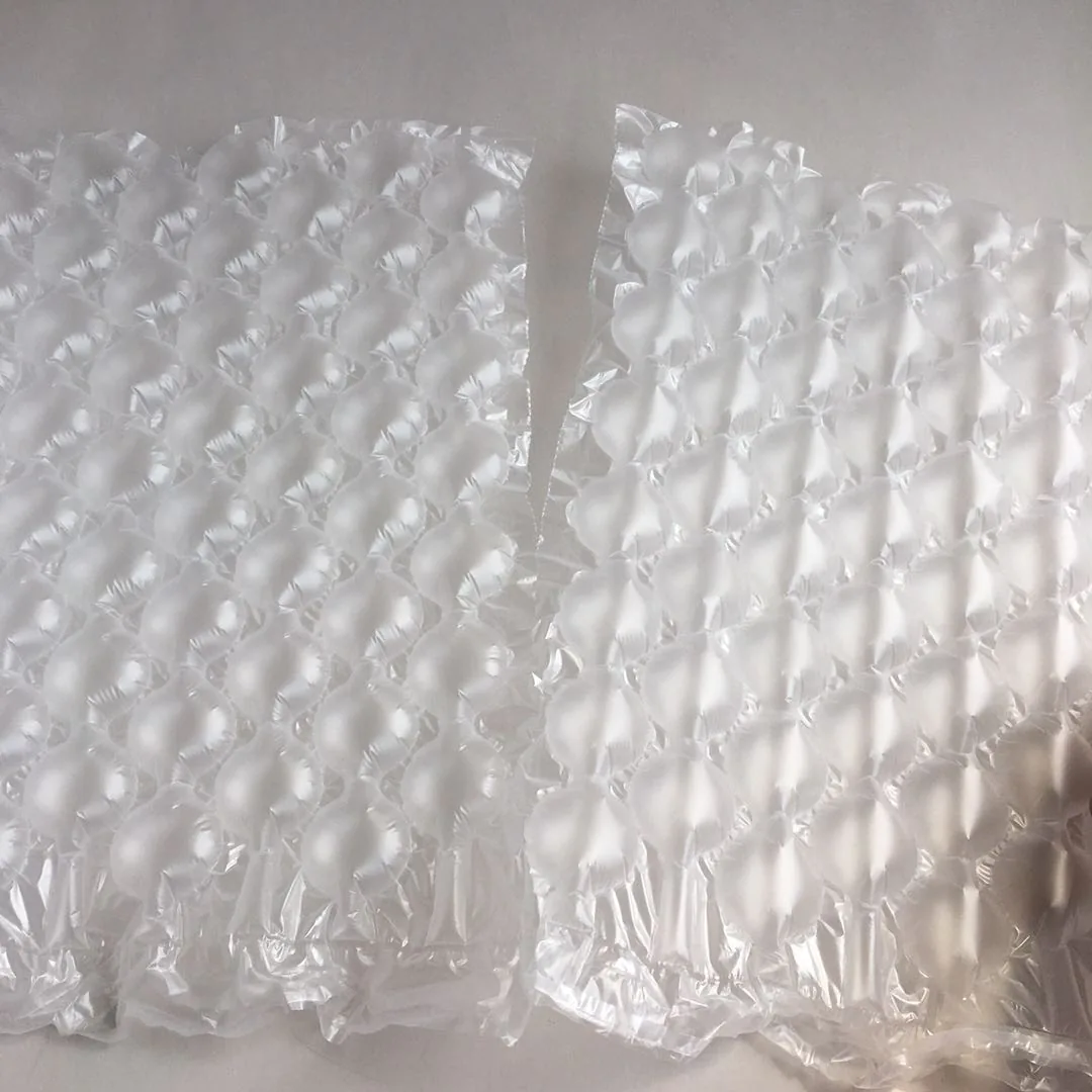 Two sheets of transparent air cushion bubble packaging lying on a plain white surface