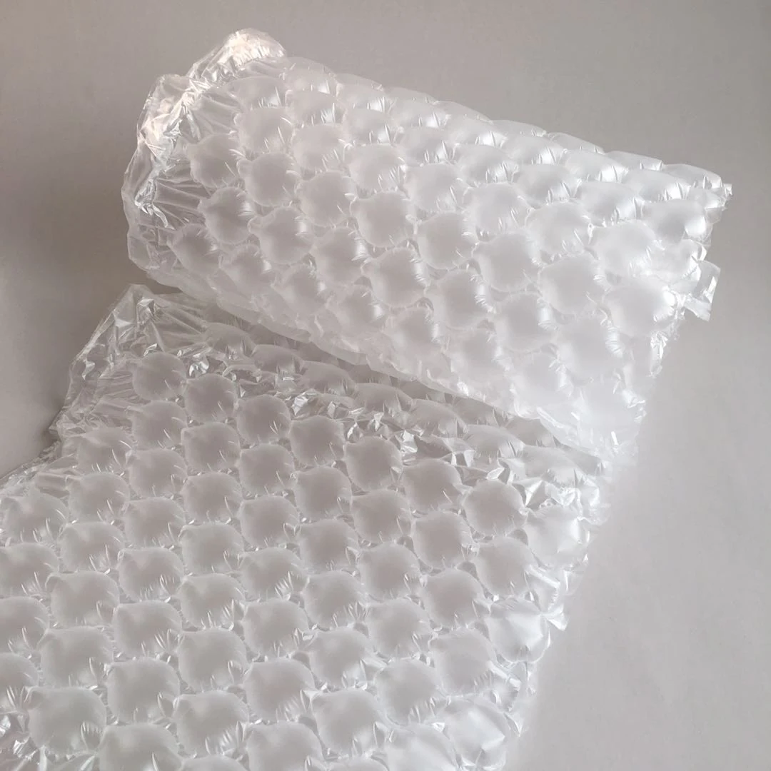 Roll of clear air bubble cushioning film partially unrolled on a plain light gray background