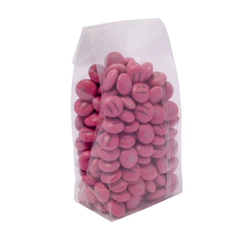 A clear stand-up pouch filled with pink coated candies.